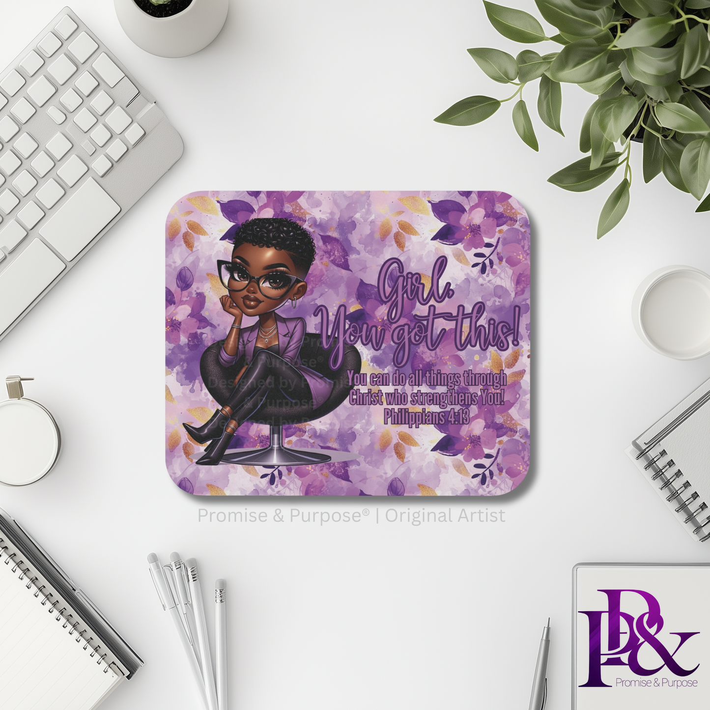 Mouse pad with motivational quote and illustration on a desk with office supplies