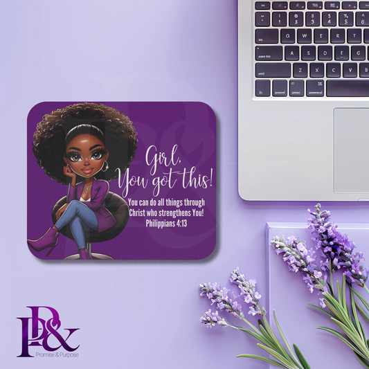 Purple mousepad with a black woman and motivational quote on a purple surface with a laptop and lavender flowers.